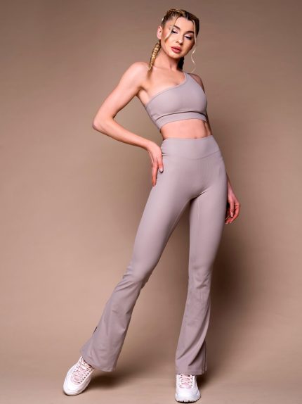 Beige flared leggings set with sports bra with one shoulder.