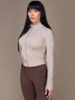 Women's sports jacket in beige color for workouts, the pattern is on the body and has a breathable fabric that prevents sweating