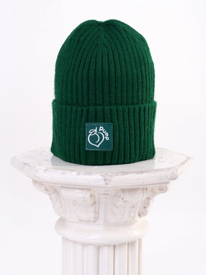 Dark green winter hat type beanie with leather "Peach Pump" logo in the front