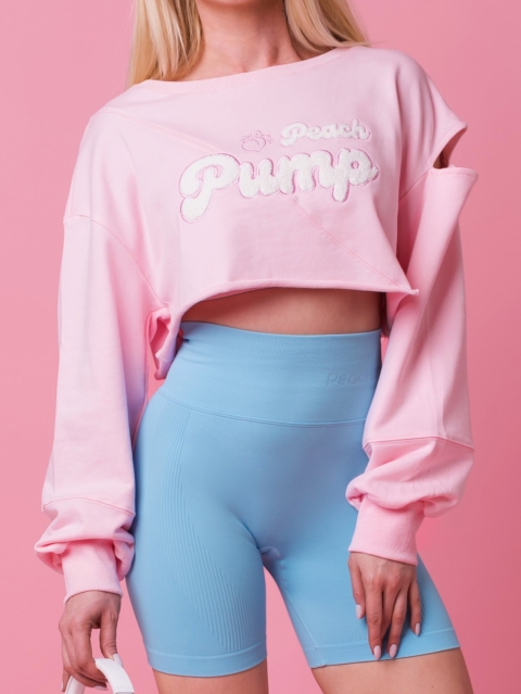 Women's pink cropped sweatshirt with soft embroidery and wide sleeves.