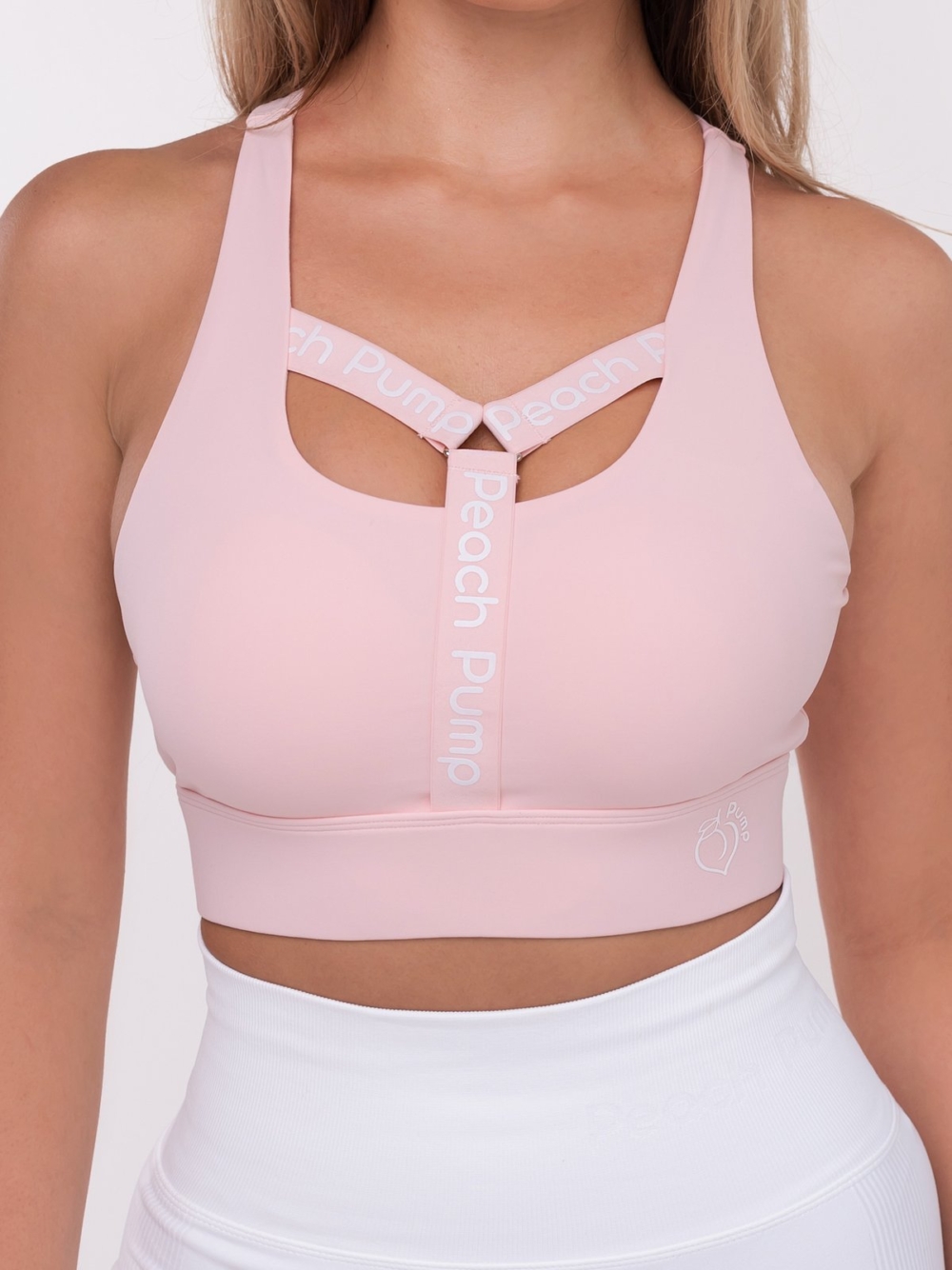 Pink sports bra with Peach Pump Y inscription