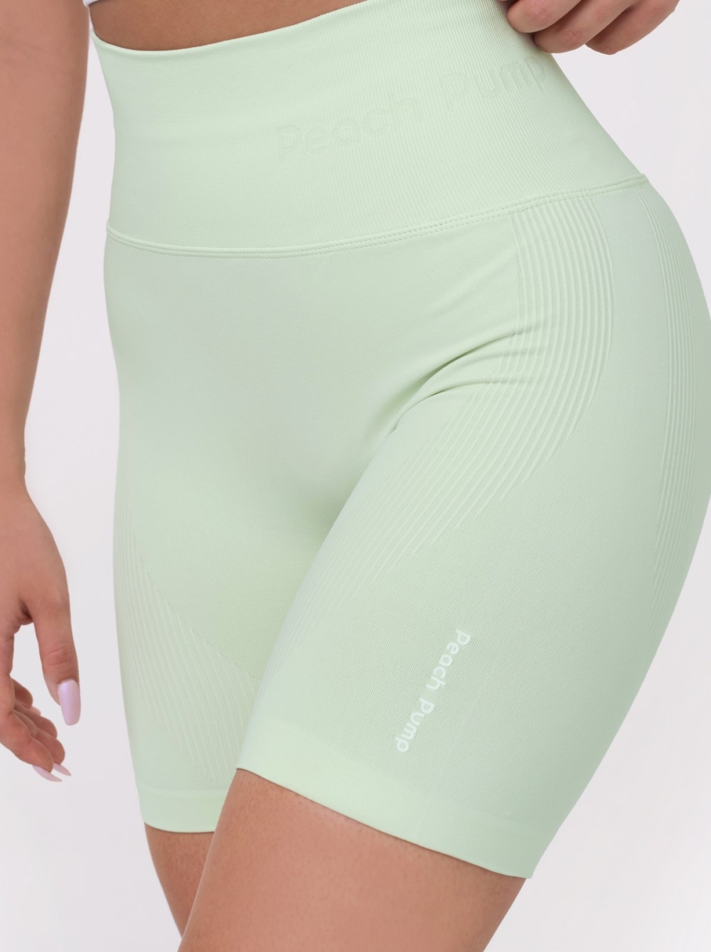 Women's sports set in light green, short leggings and push-up bra