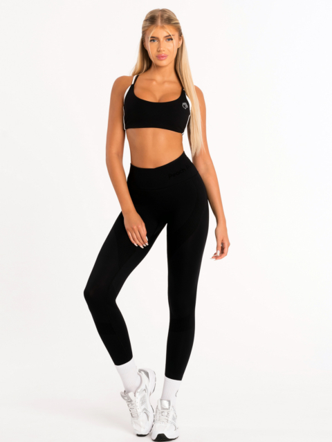 Black sports bra with white elements and lift-effect pads