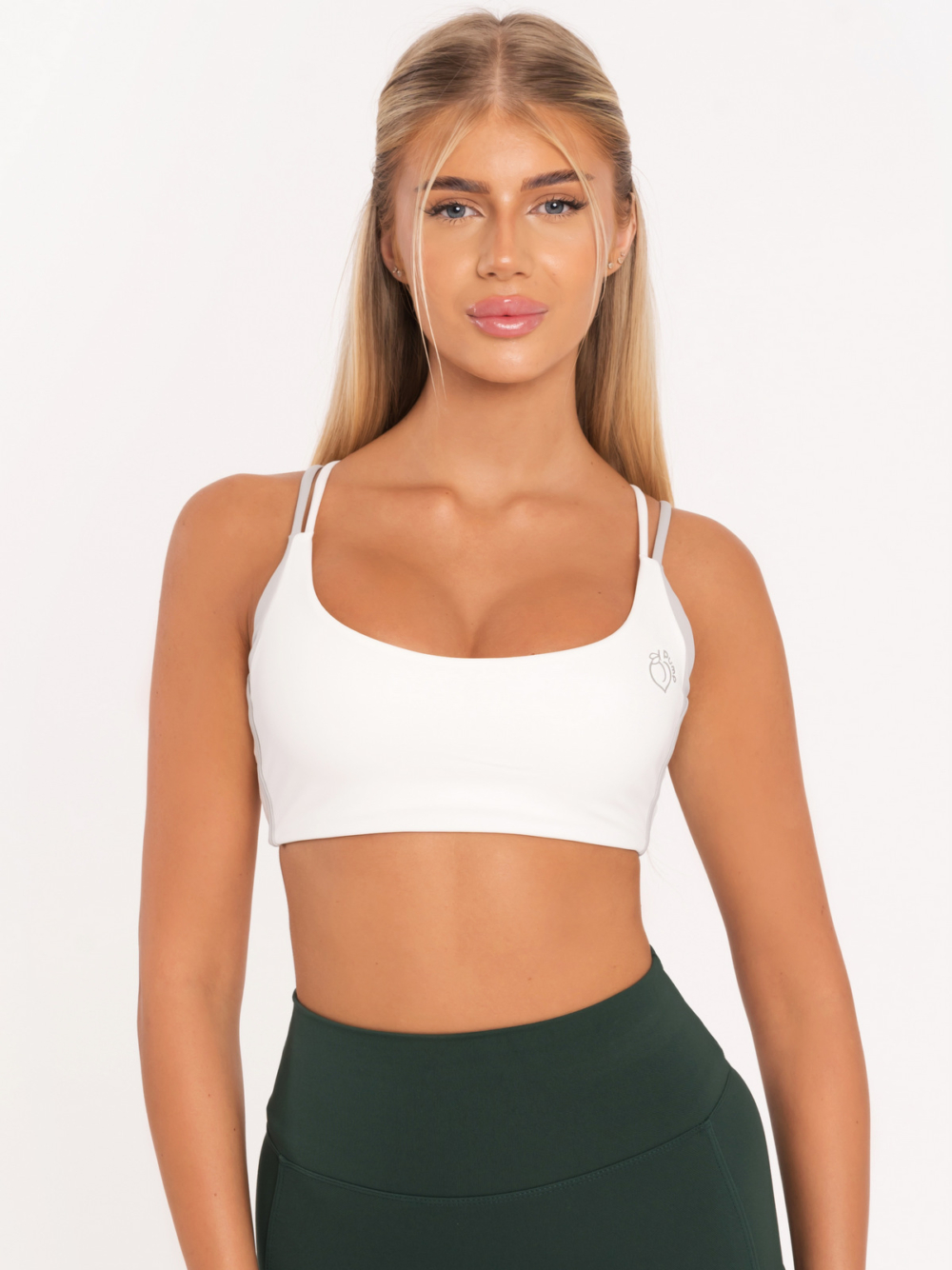 White sports bra with pads and gray Peach Pump logo on the front