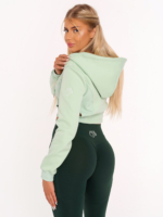 Light green cropped hoodie with cut-out waist details and shoulder embroidery