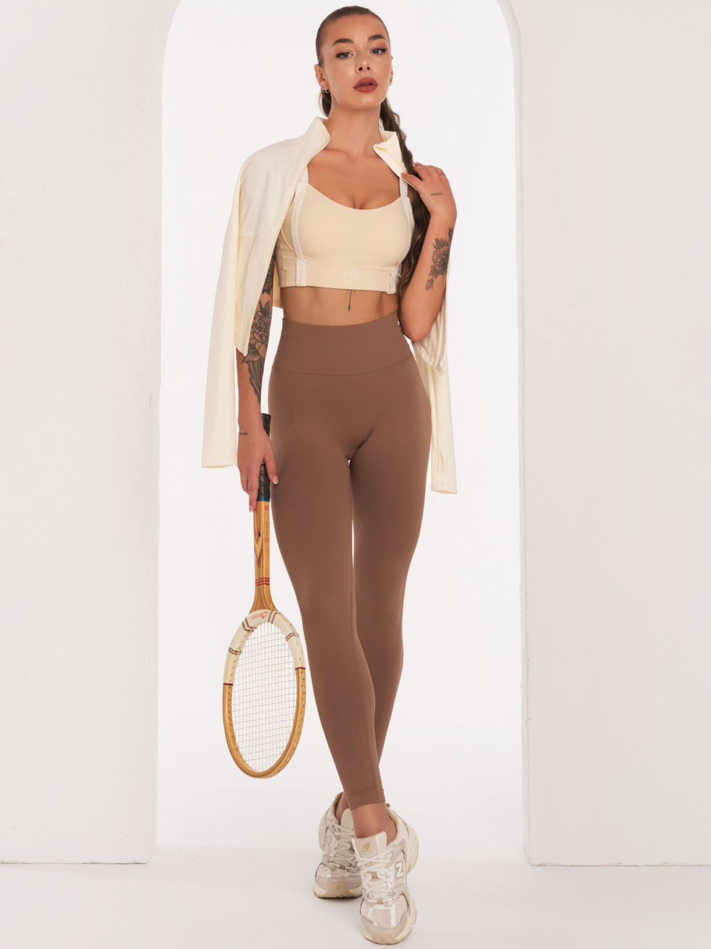 Beige sports bra with Peach Pump prints along the length