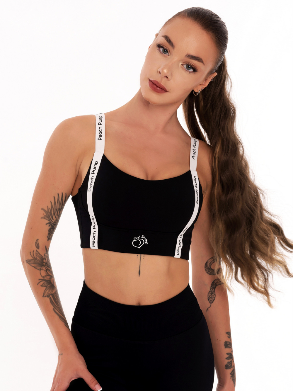 Black sports bra with front straps and Peach Pump prints