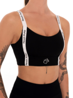 Black sports bra with white straps and black Peach Pump prints
