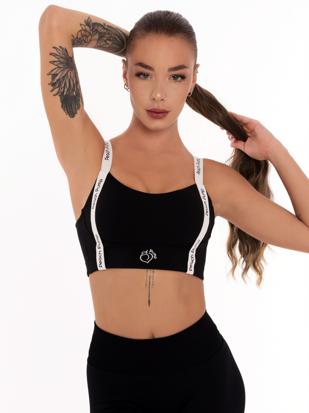 Black sports bra with Super Push-Up effect and white straps with black Peach Pump prints