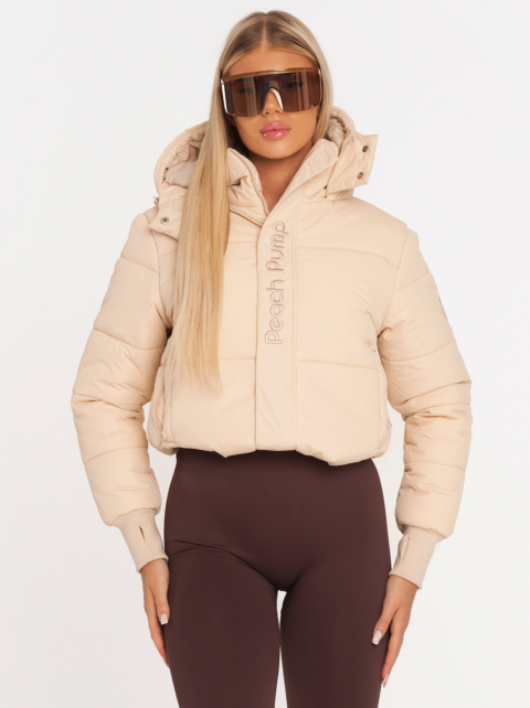 Beige thick winter jacket with hood and Peach Pump embroidery on the front<br>