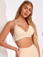 Beige sports bra with an adjustable back strap and soft stretch fabric.