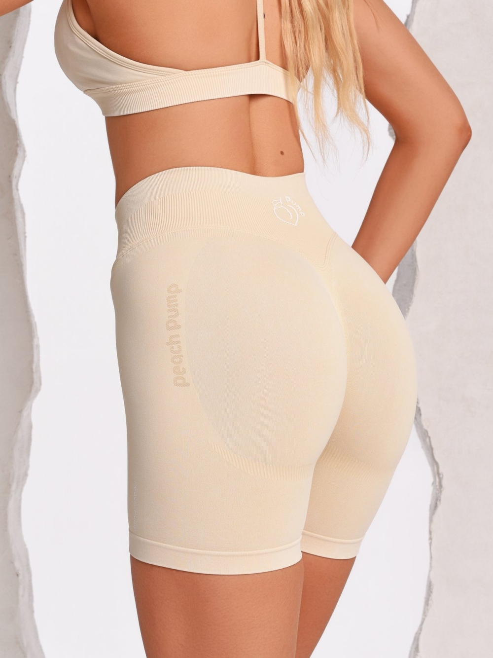 Beige Gym Shorts with a lifting effect and Peach Pump logos knitted into the fabric.