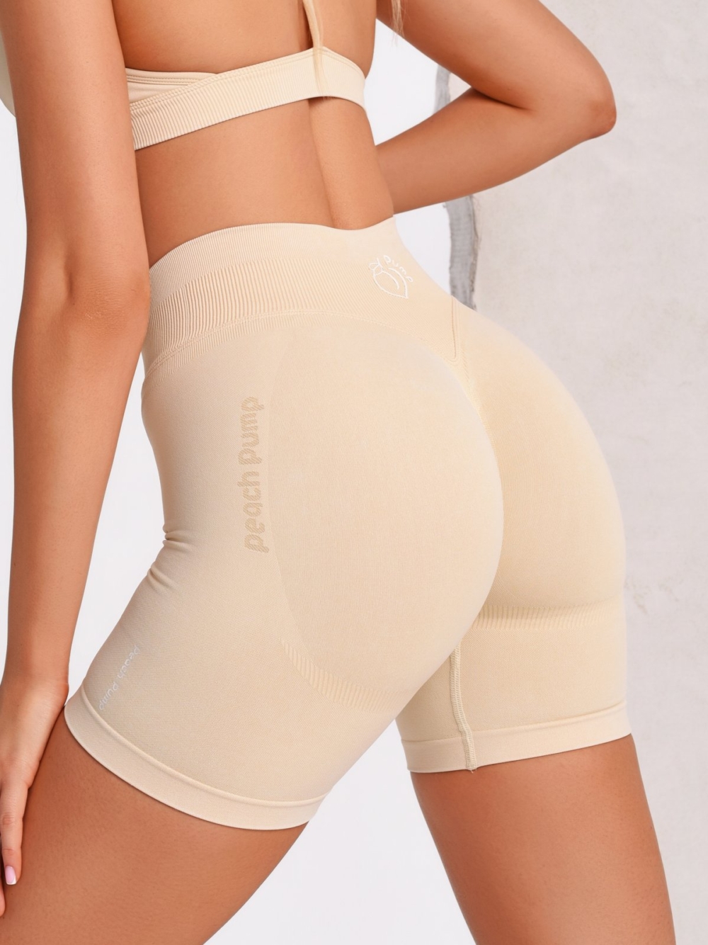 Women's Seamless Beige Gym Shorts with a high waist and seamless fabric for maximum comfort.