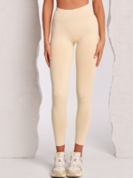 Women's beige leggings made from soft stretch fabric with Peach Pump branding knitted into the fabric.