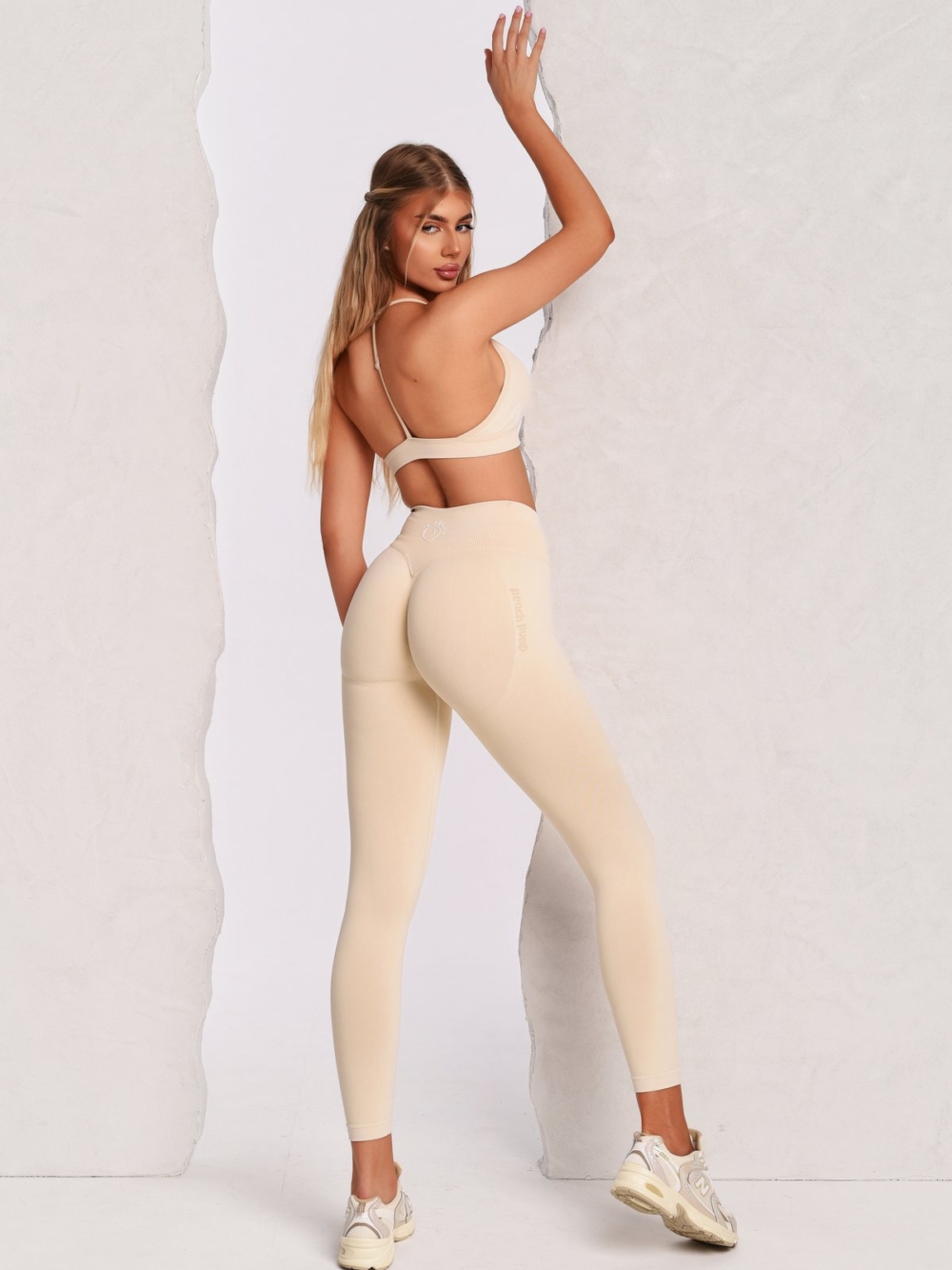 Beige leggings with Peach Pump branding and a body-hugging fit.