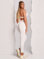 Seamless white leggings with Peach Pump branding knitted into the fabric along the curves of the hips.