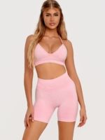 Women's pink sports bra with removable padded cups and an adjustable back strap.