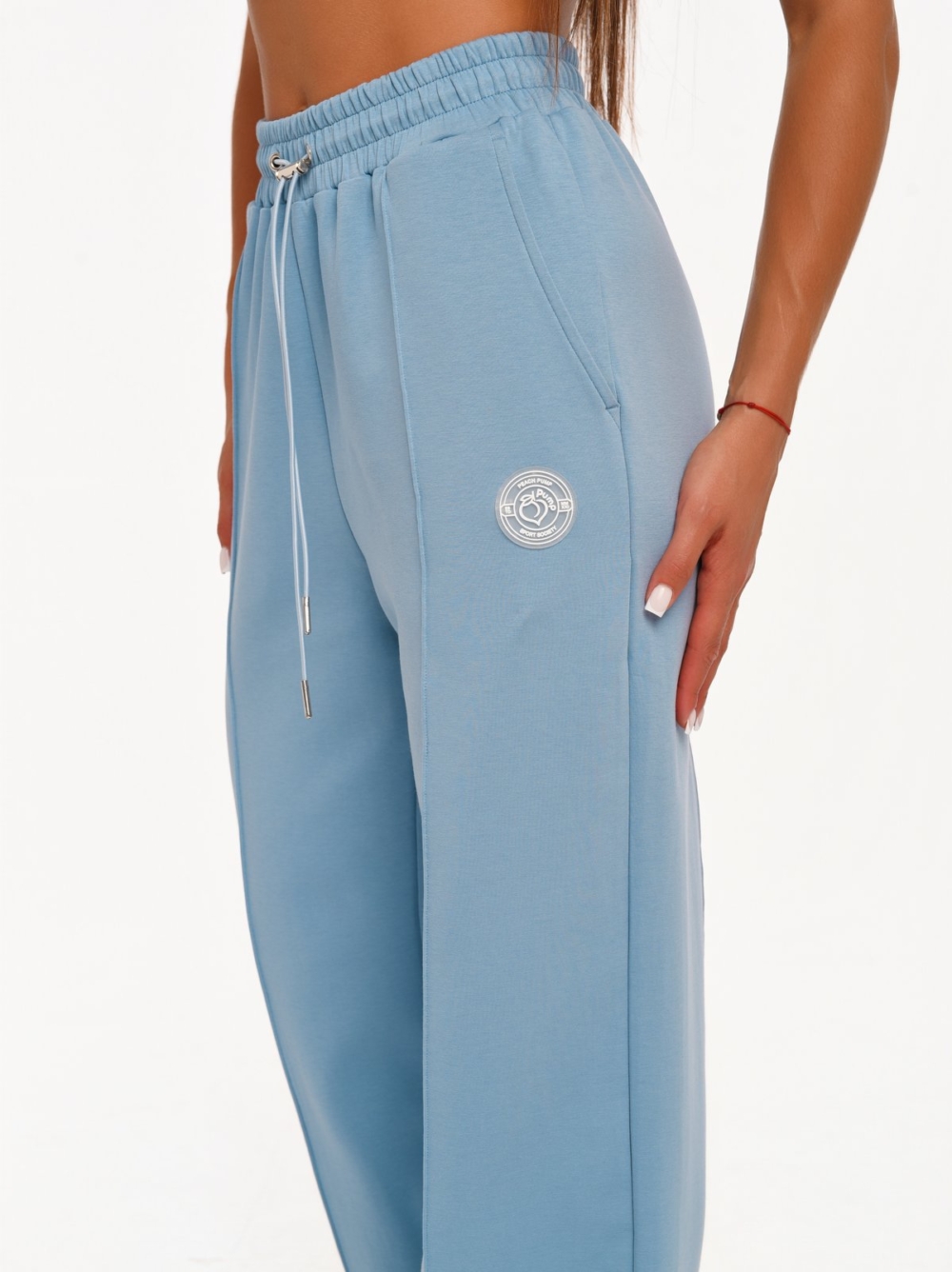 Women's light blue wide leg joggers with decorative vertical seams.