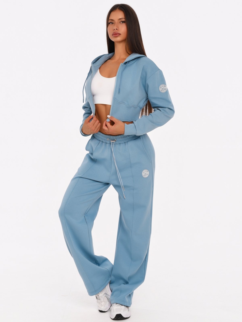 Women's light blue gym set with wide leg joggers and corset-inspired cropped hoodie.