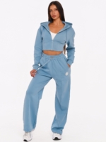Women's light blue gym set with cropped zip hoodie and wide leg joggers.
