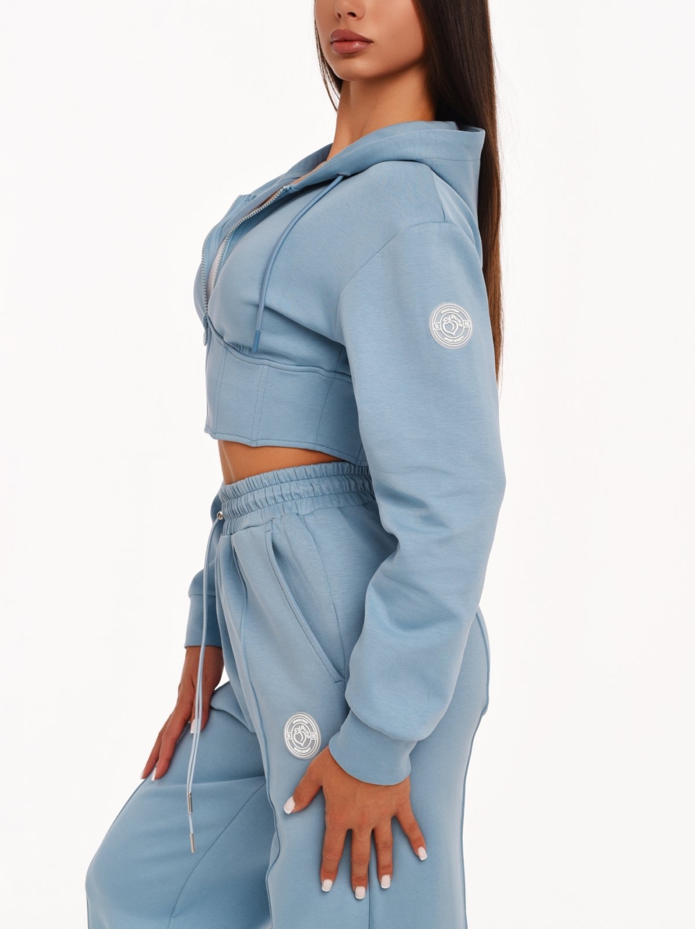 Light blue cropped hoodie with a large hood and modern sporty look.