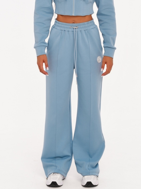 Women's light blue wide leg joggers made from soft cotton-blend fabric.