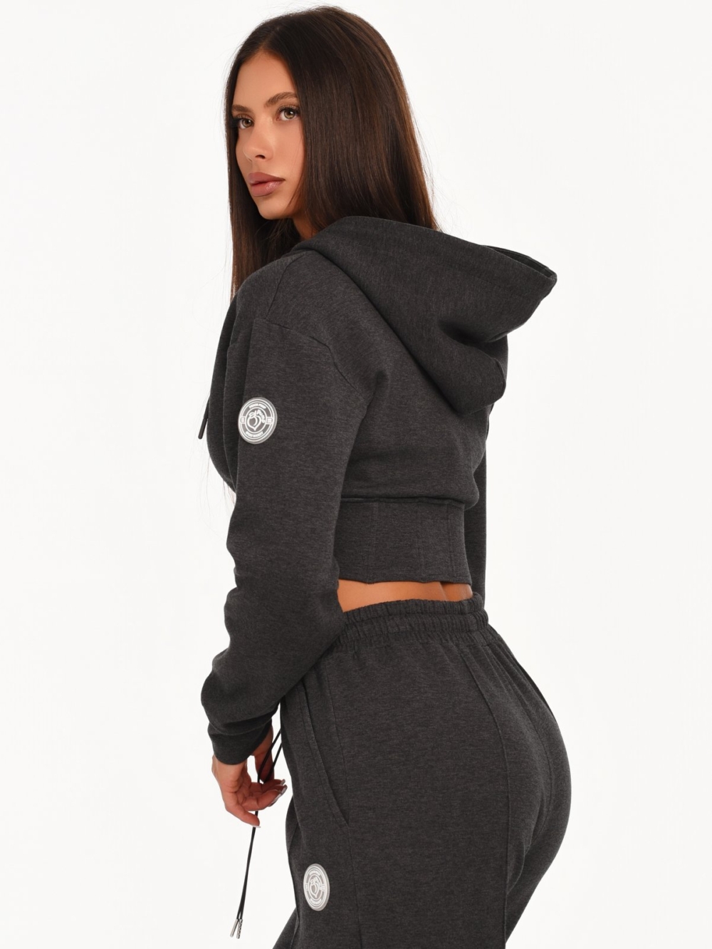 Graphite black cropped hoodie with rubberized Peach Pump logo on the shoulder.