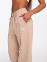 Women's beige joggers with side pockets and Peach Pump logo.
