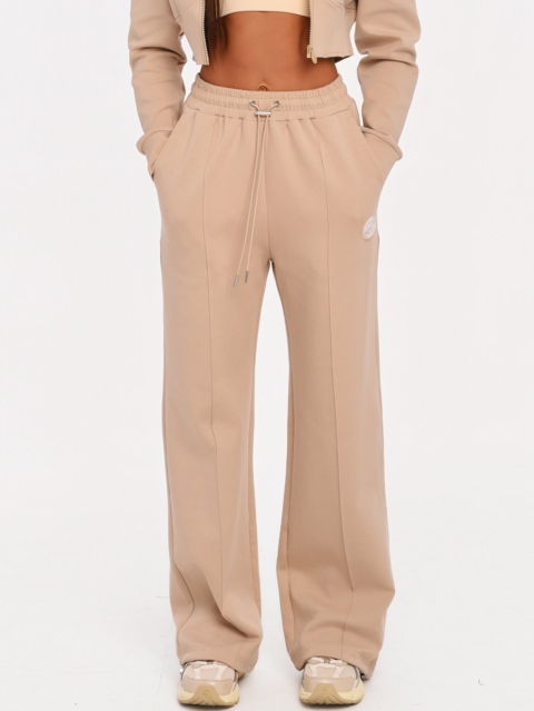Women's beige wide leg joggers made from soft cotton-blend fabric.