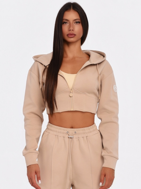 Beige cropped hoodie with large hood and waist-enhancing corset seams.