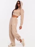 Beige gym set with wide leg joggers and adjustable drawcords.