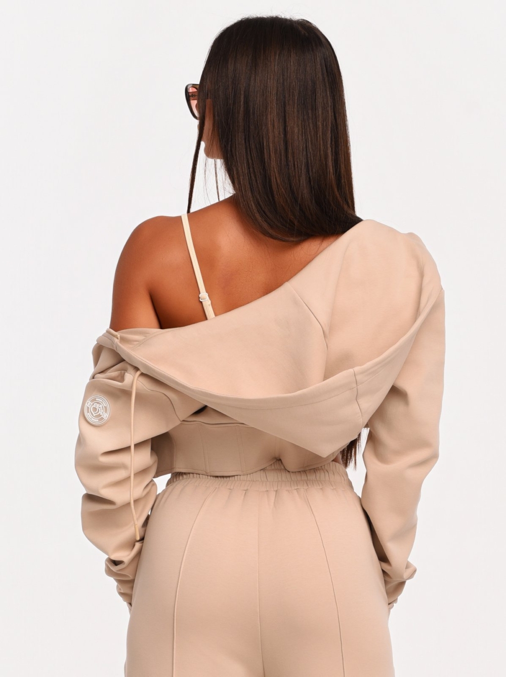 Beige cropped hoodie with front zipper for a modern everyday look.