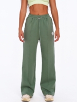 Women's green wide leg joggers with decorative vertical seams.