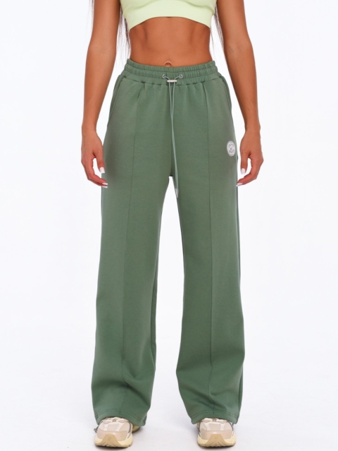 Women's green wide leg joggers with decorative vertical seams.