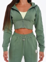 Women's green gym set with wide leg joggers and corset-inspired cropped hoodie.