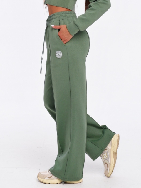 Women's green joggers with an elastic waistband and adjustable drawstrings.