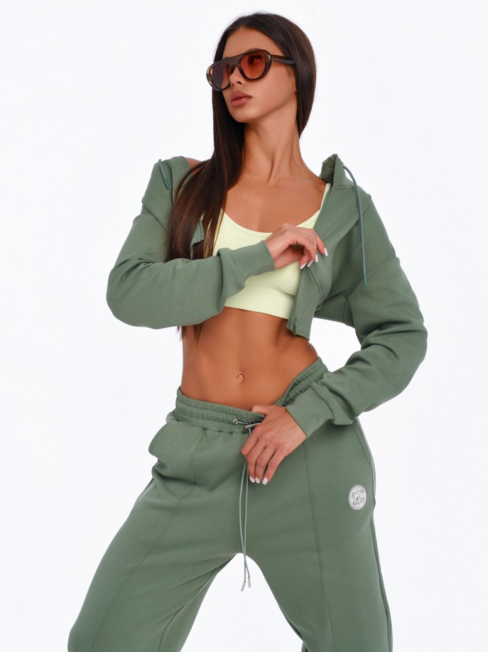 Women's green cropped hoodie with corset-inspired design for a sculpted silhouette.