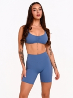 Women's blue sports bra with thin adjustable straps and Super Push-Up pads.