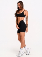 Women's short sports leggings in black made from opaque, stretchy fabric.