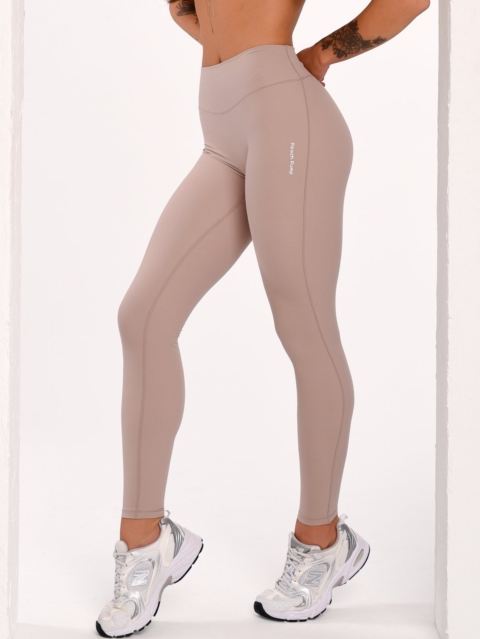 Women's beige sports leggings with a mid-rise waist and Invisible Scrunch.