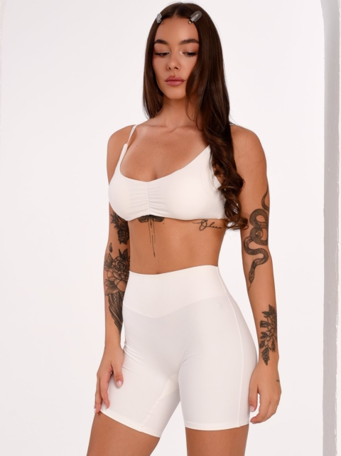 Women's sports bra in an Off-White shade with thin straps and an adjustable fastening.