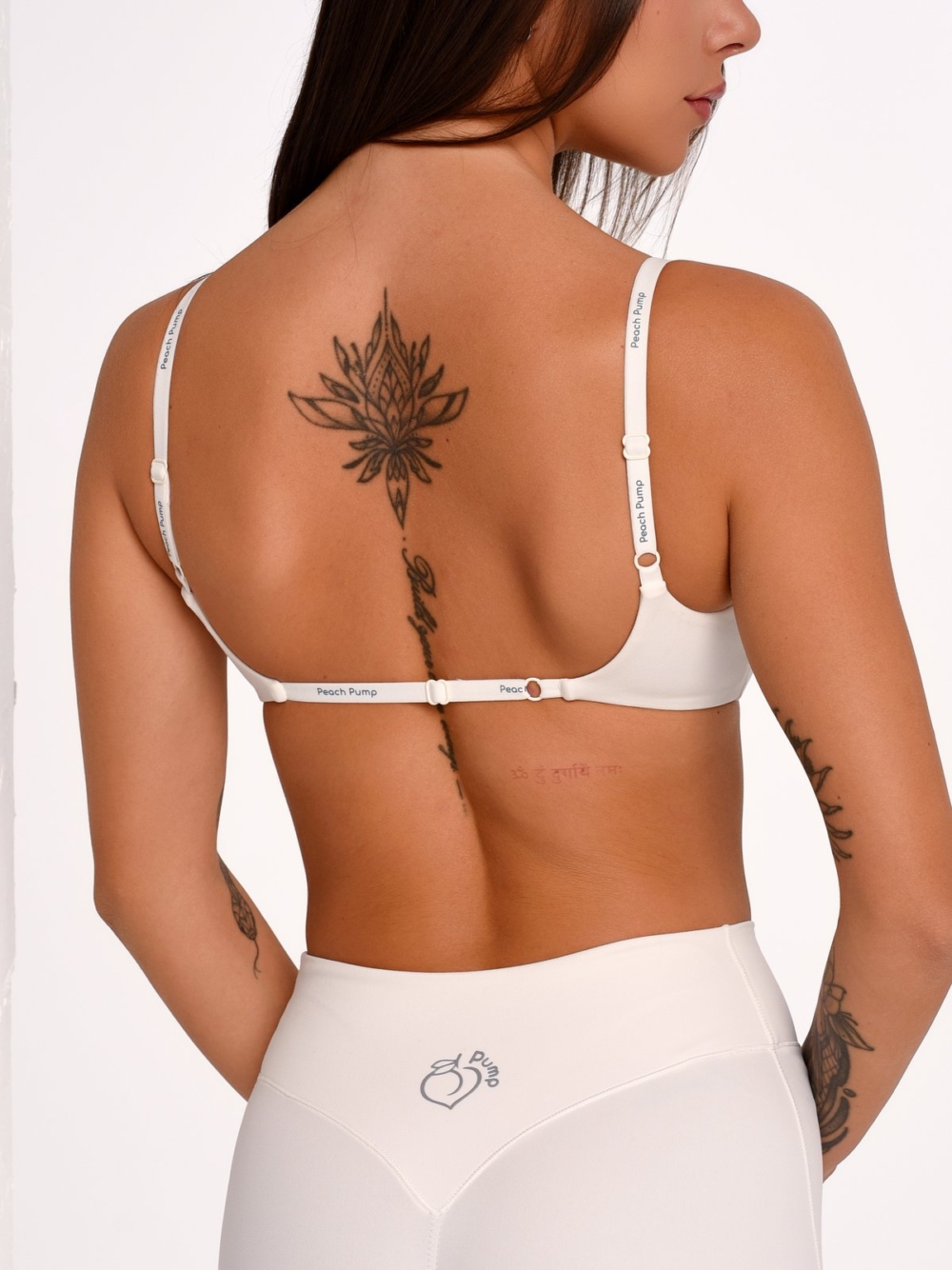 Women's Off-White sports bra with an adjustable back for a personalized fit.