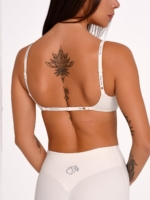 Women's Off-White sports bra with an adjustable back for a personalized fit.