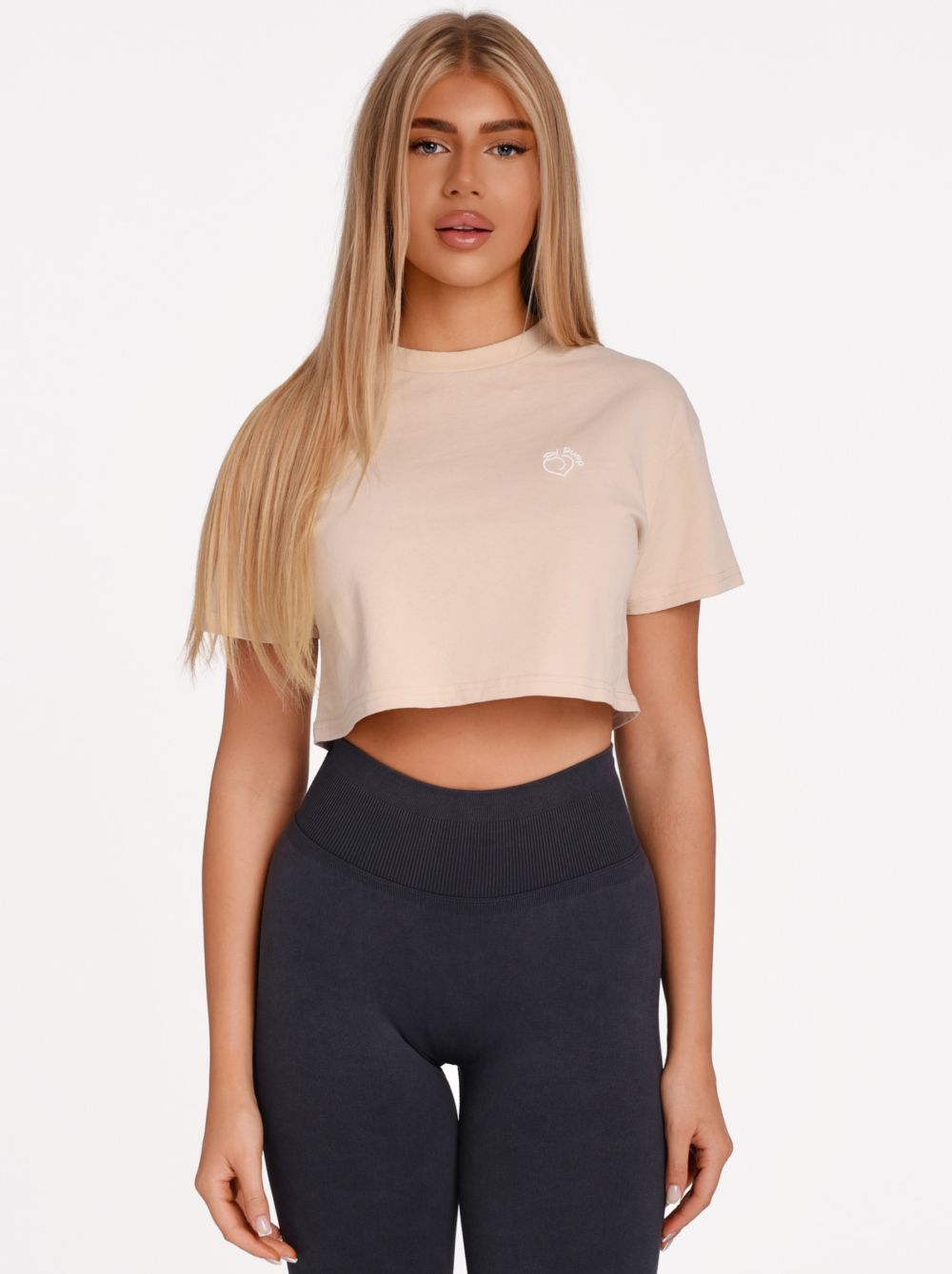 Cream Cotton Fitness Crop T-Shirt with Peach Pump Rubber Logo.